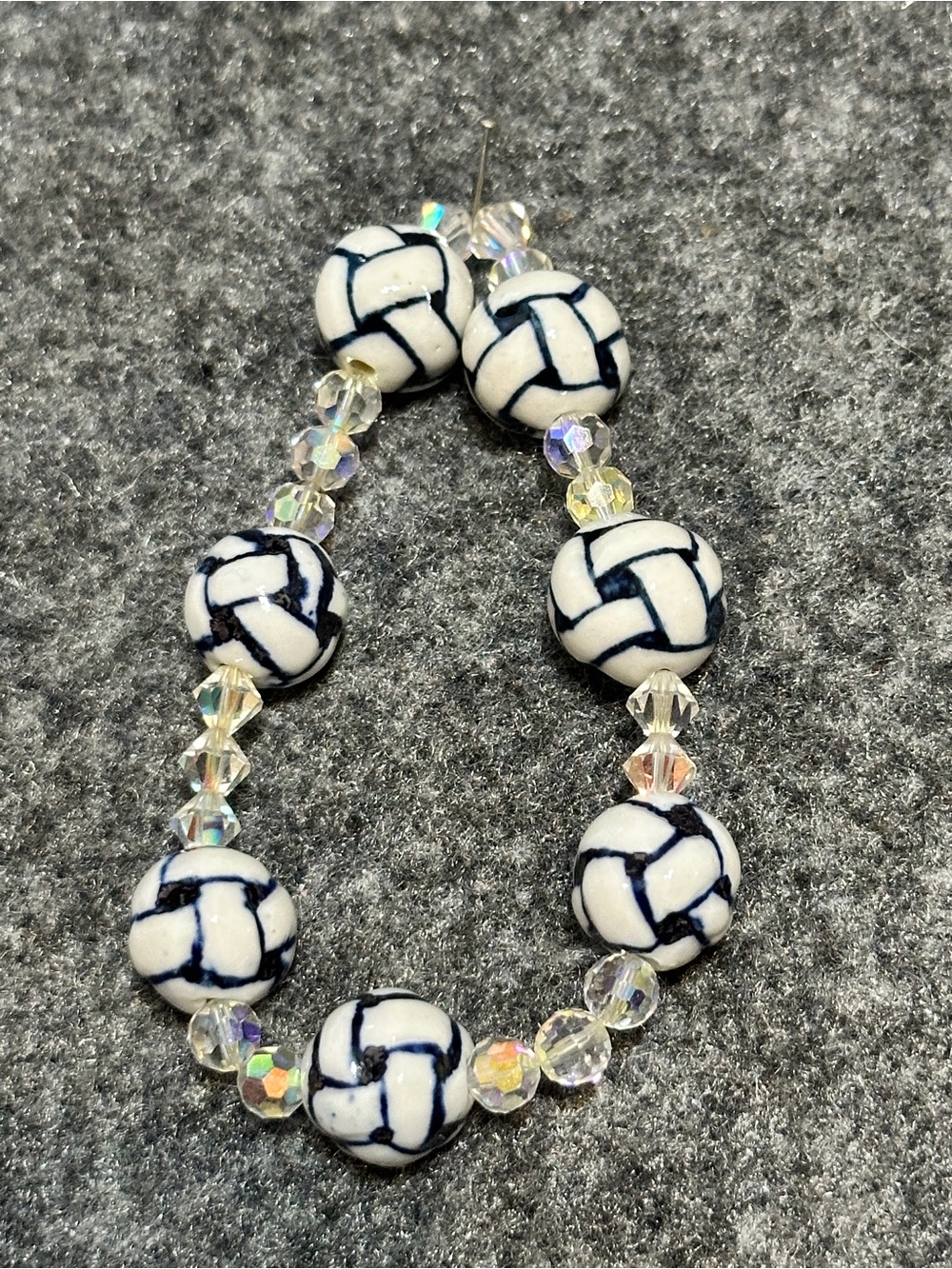 Elastic beaded sports bracelet featuring white-and-black volleyball-patterned
